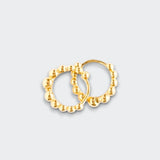 Little Moony Pair of gold hoop earrings on a light gray background