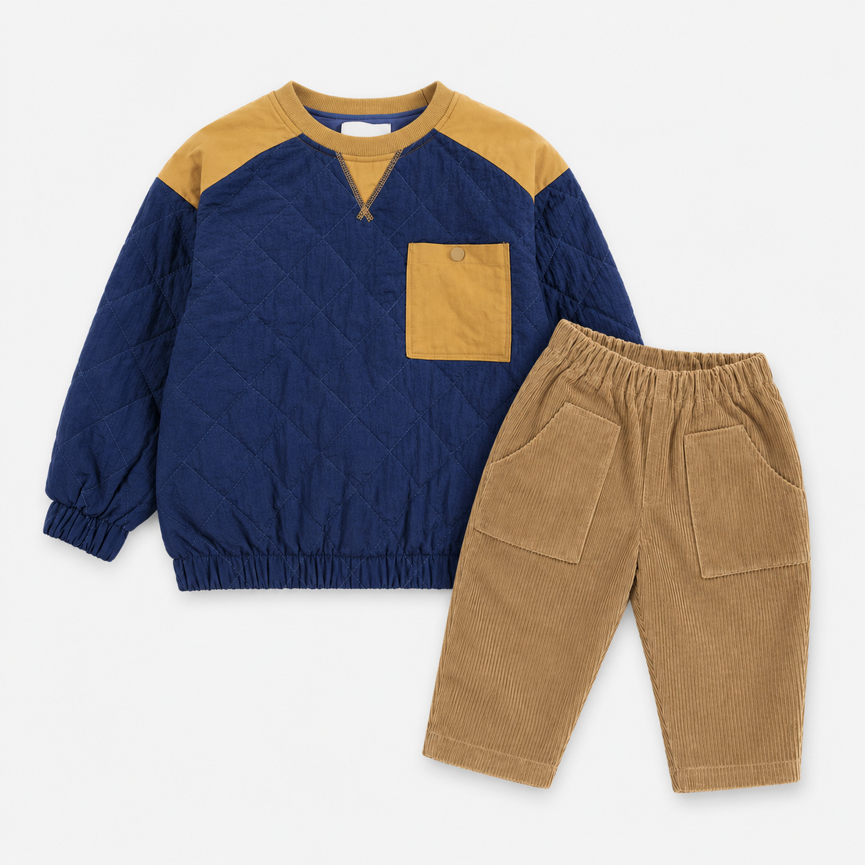 A two-piece children's outfit set featuring a navy blue and mustard yellow quilted long-sleeve top with a chest pocket, paired with tan corduroy pants with elastic waist and large front patch pockets, laid flat on a white background.