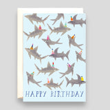 Greeting Card: Sharks Happy Birthday. Blue card with illustrations of sharks wearing birthday hats. 