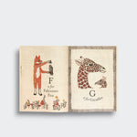 Fox and giraffe pages from ABC: An Animal Alphabet Adventure, showing a fox holding a falcon and two giraffe portraits on a light gray background.