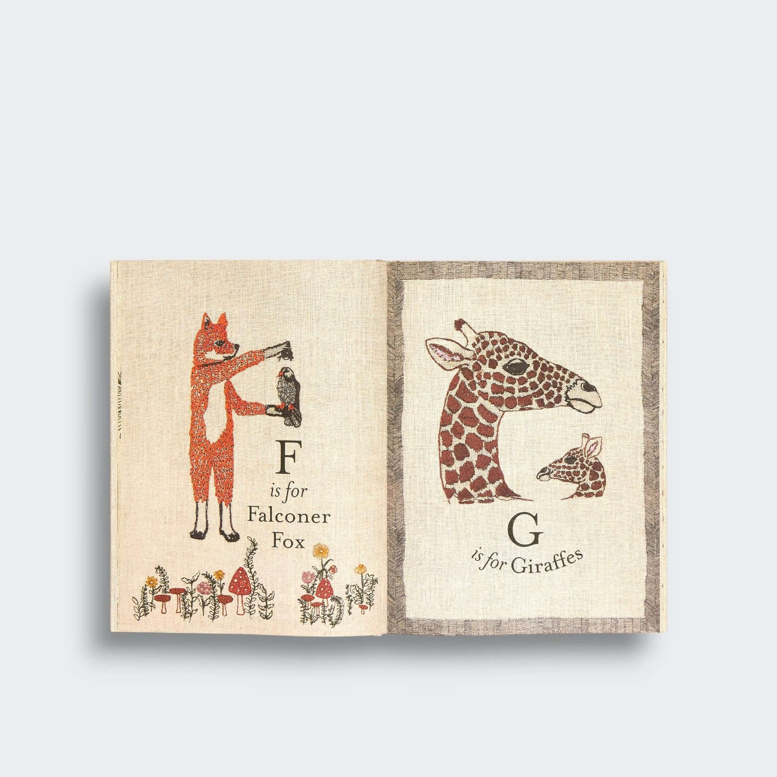 Fox and giraffe pages from ABC: An Animal Alphabet Adventure, showing a fox holding a falcon and two giraffe portraits on a light gray background.