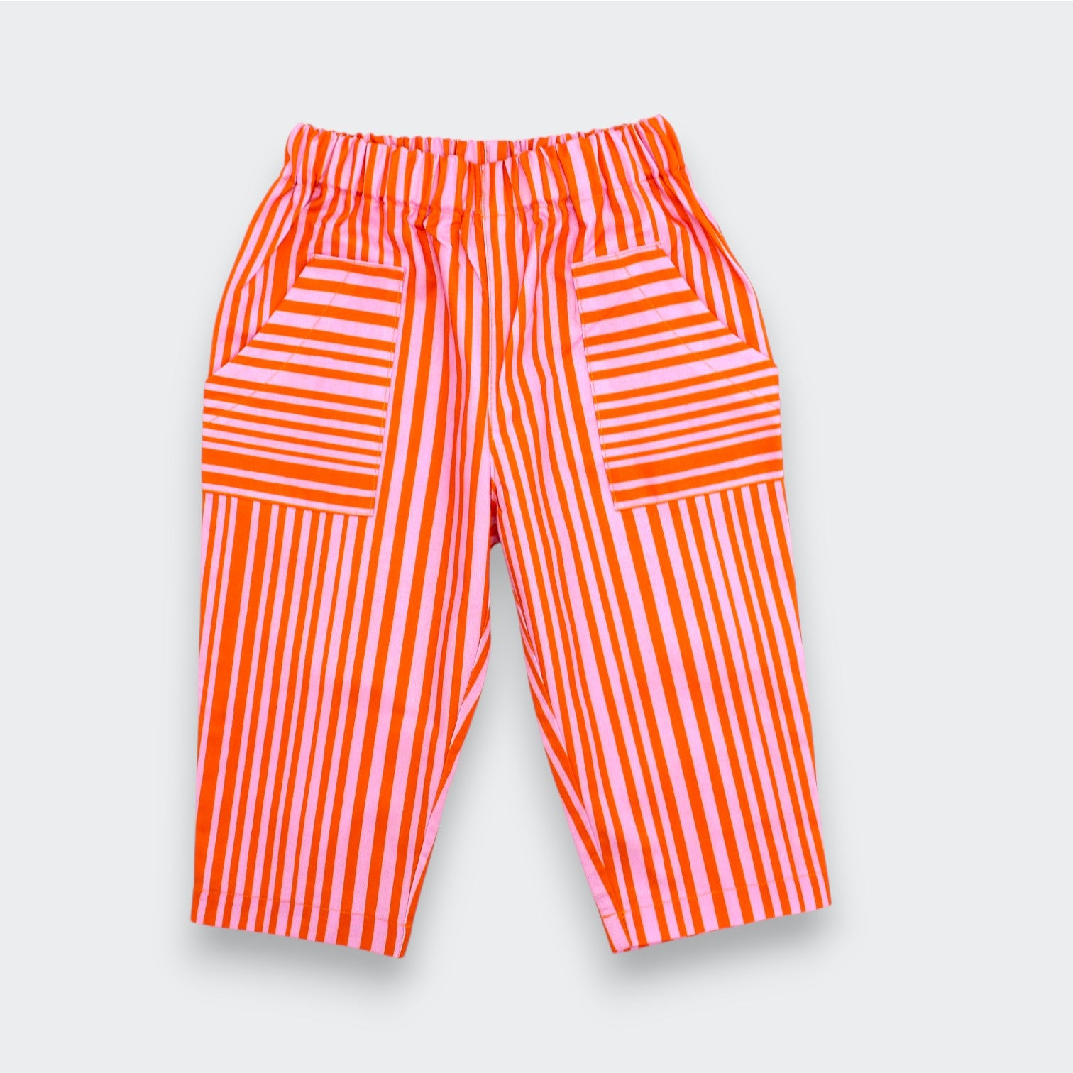 Little Moony cherry red and pink stripe patch pocket pants for baby and toddler flat lay view