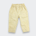 Little Moony cream and brown cross-stitch print cotton baby and toddler pants flat lay view