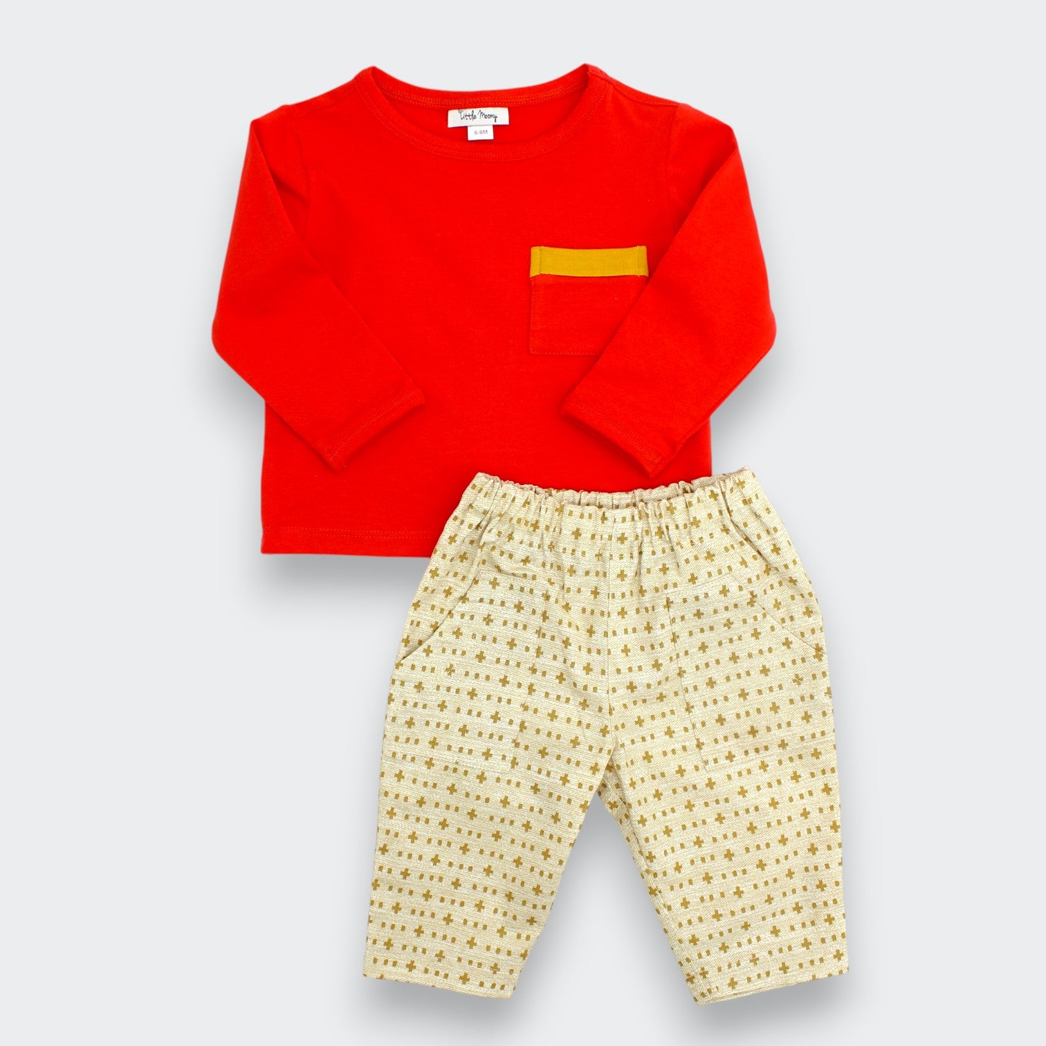 Little Moony cross-stitch print cotton baby pants styled with a red tee