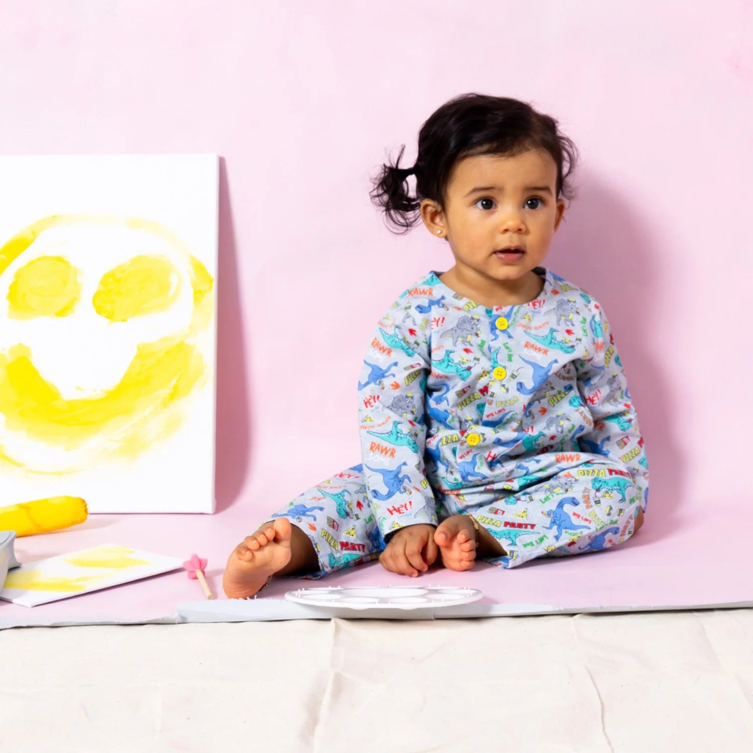Baby wearing Little Moony Dino Pizza Party jumpsuit, handmade baby clothes designed in NYC