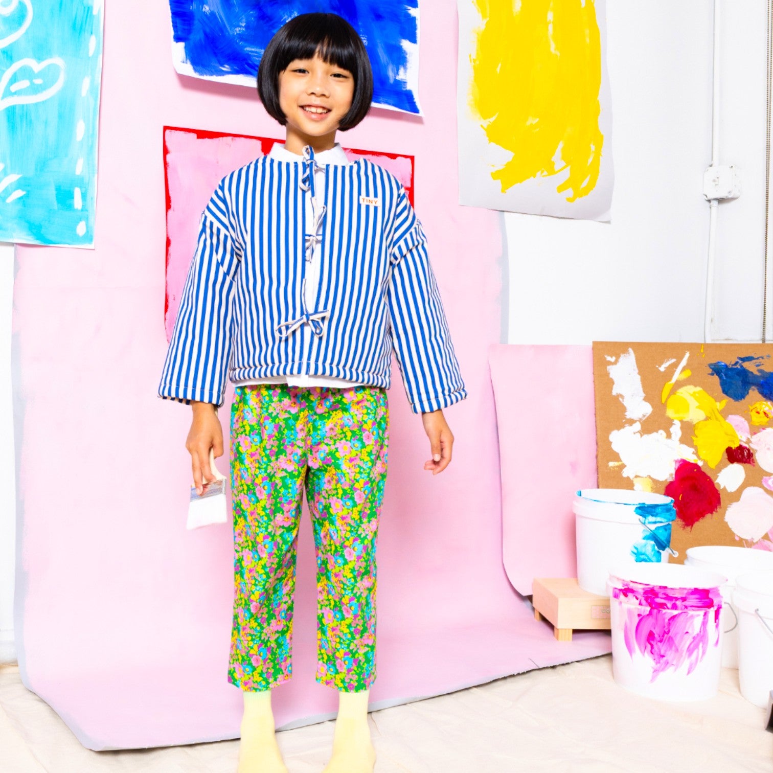 Toddler wearing Little Moony Little Garden floral pants, handmade children's wear designed in NYC by Little Moony.

