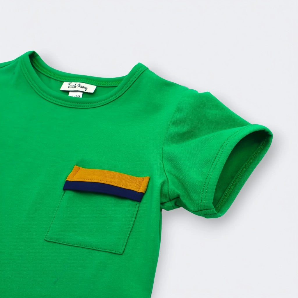 Close up of color blocked mustard yellow and navy pocket on Little Moony Jade Green Pocket Tee