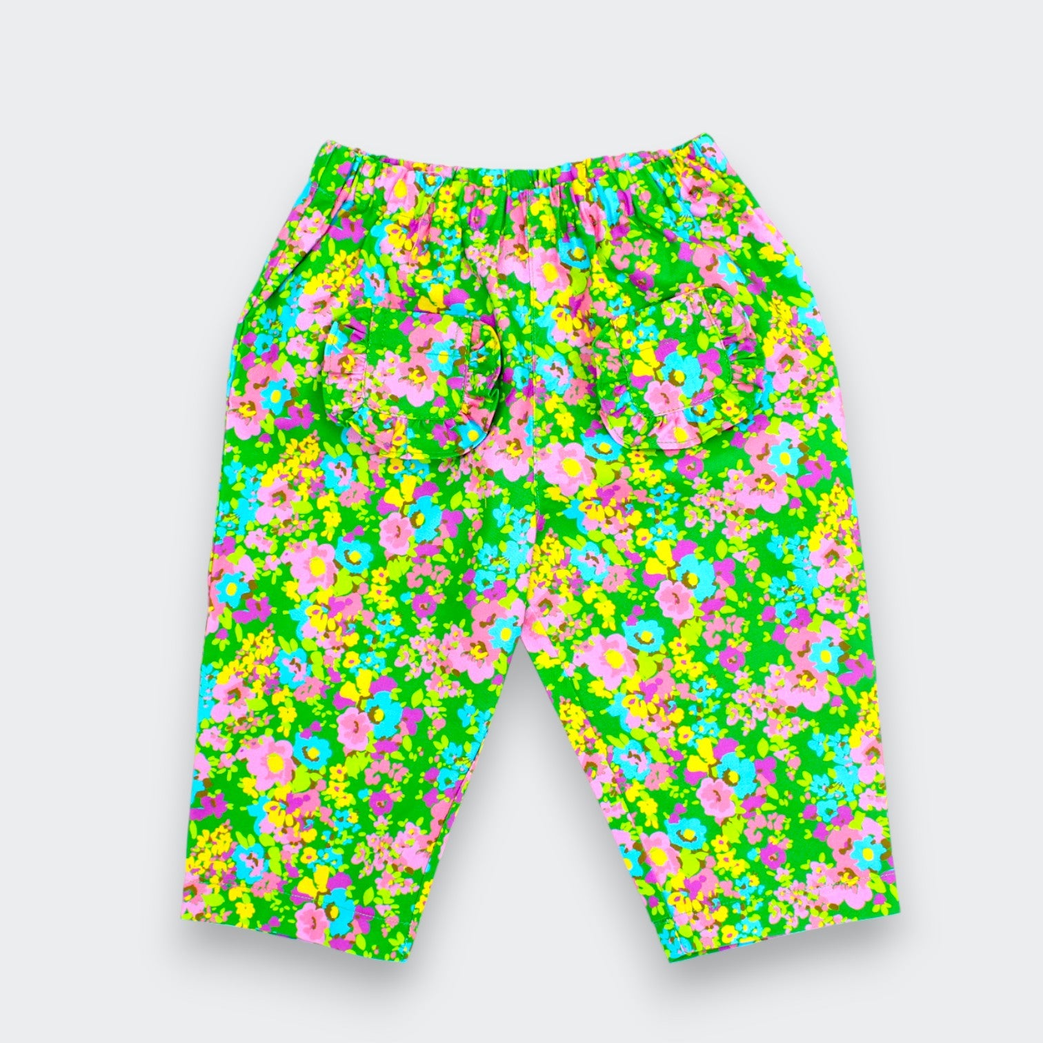 Little Garden floral pants for baby and toddler girls in vivid green with ruffle pockets for Little Moony
