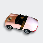 Top view of the Luft Pop pink toy car, showing its open cockpit, metallic trim, and red rear lights on a light gray background.