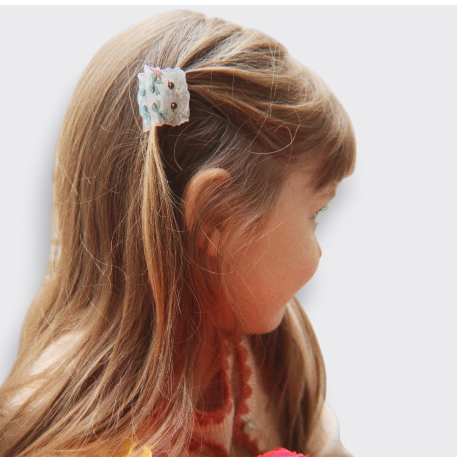 Little Moony Small Hair Claw in colorful multi designs for girls ages 3 and up worn by a little girl