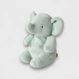 Side view of a soft mint elephant plush toy with a curled trunk, large ears, and a silver neck ribbon on a light gray background.