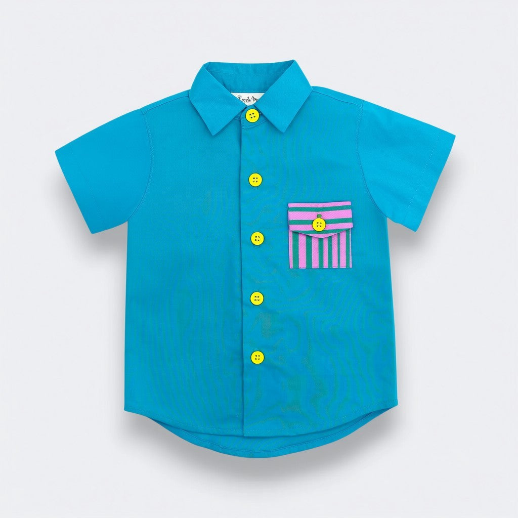 Blue children's shirt with yellow buttons and a striped pocket on a light gray background