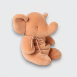 Side view of a vintage rose elephant plush toy with an upturned trunk, large ears, and a matching neck bow on a light gray background.