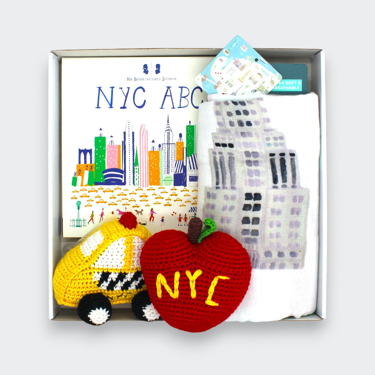 New York City baby gift set with NYC ABC board book, cotton gauze swaddle, taxi rattle, and apple rattle