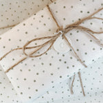 Sample picture of polka dot tissue wrap with a twine bow.