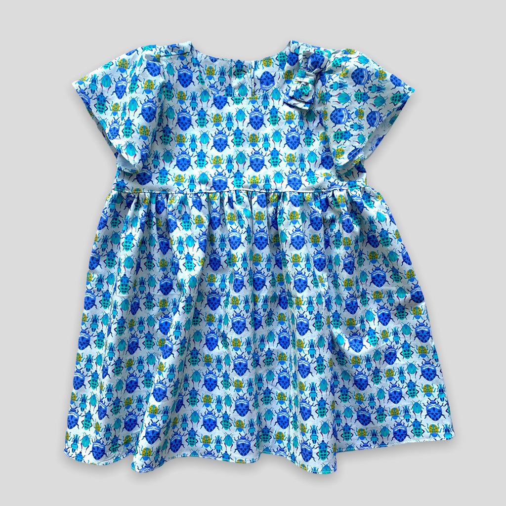 Blue Bug Dress with Tulip Sleeves and Bow for Babies and Kids. Front view.