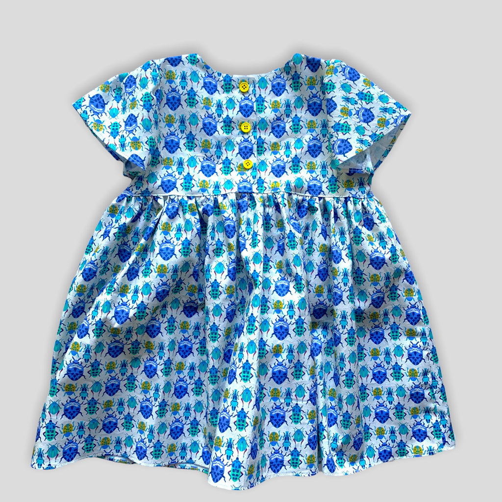 Blue Bug Dress with Tulip Sleeves and Bow for Babies and Kids. Back view.