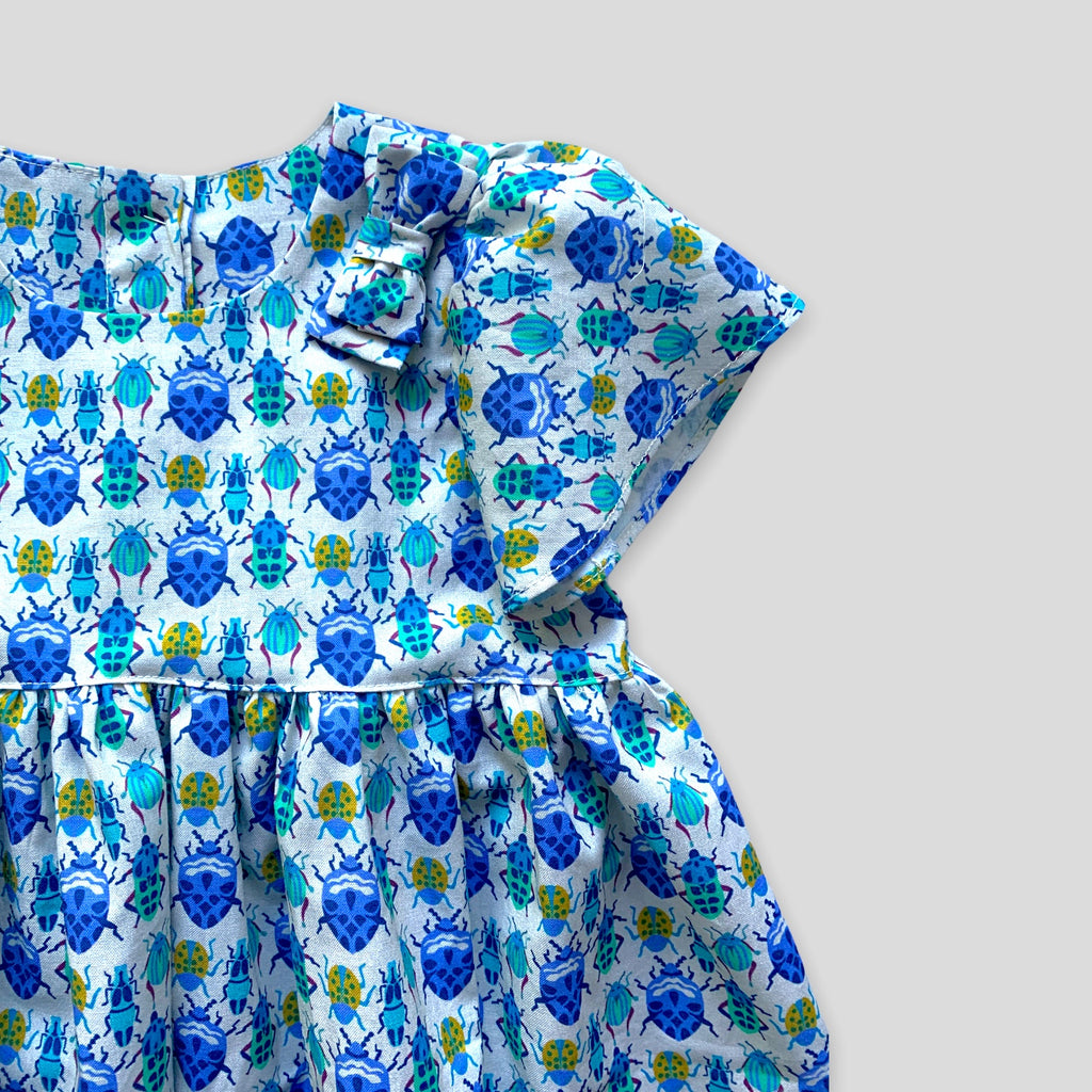 Blue Bug Dress with Tulip Sleeves and Bow for Babies and Kids. Detail view of shoulder bow.