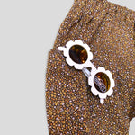 Cotton Golden Brown and Yellow Petite Fleur Harem Pants for Babies and Kids. Curated look with White Daisy Sunglasses (not included). Detail view.